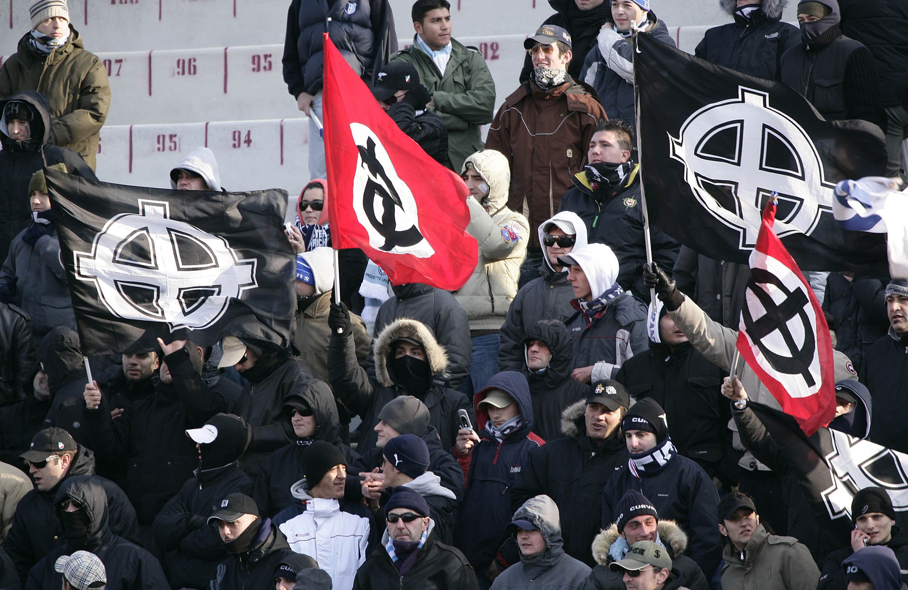 Laziosupportrar visar upp kelterkors på fotbollsläktaren. I Italien representerar symbolen fascismen.
