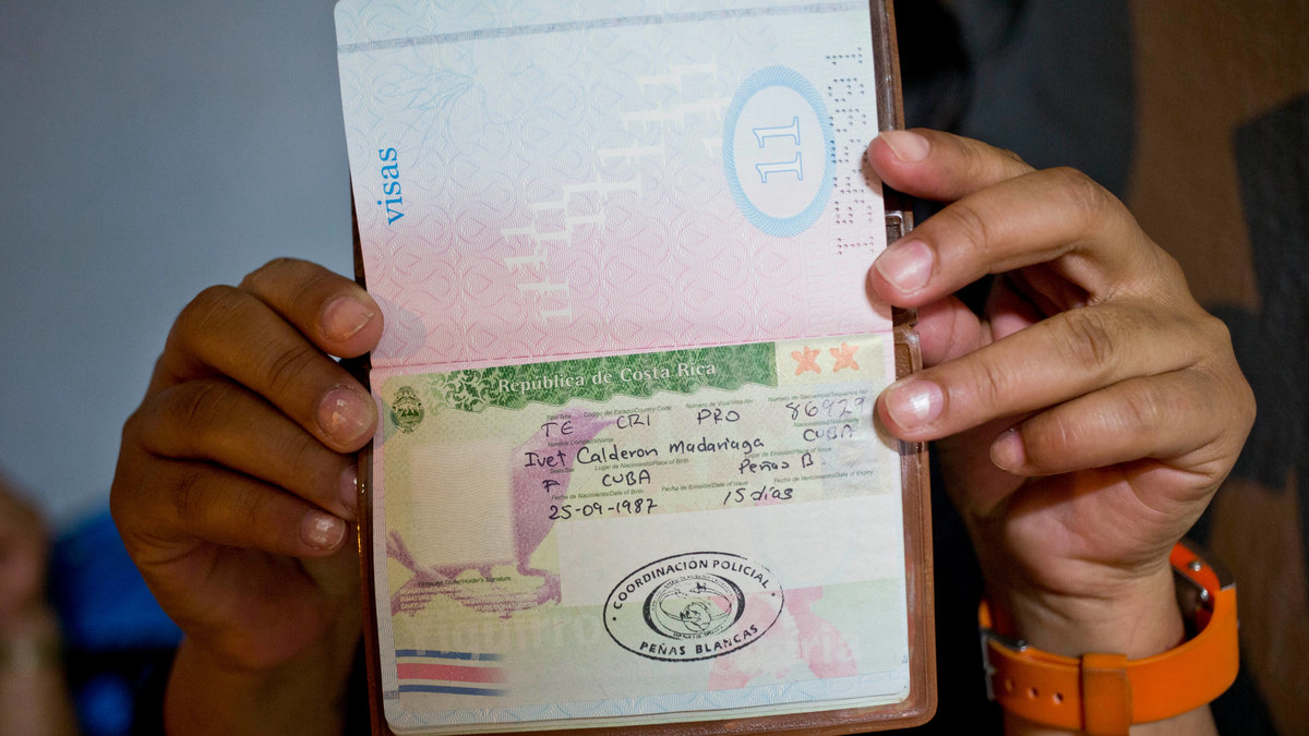 En person från Kuba visar upp sitt pass. Kubanska pass är inte med på listan. 