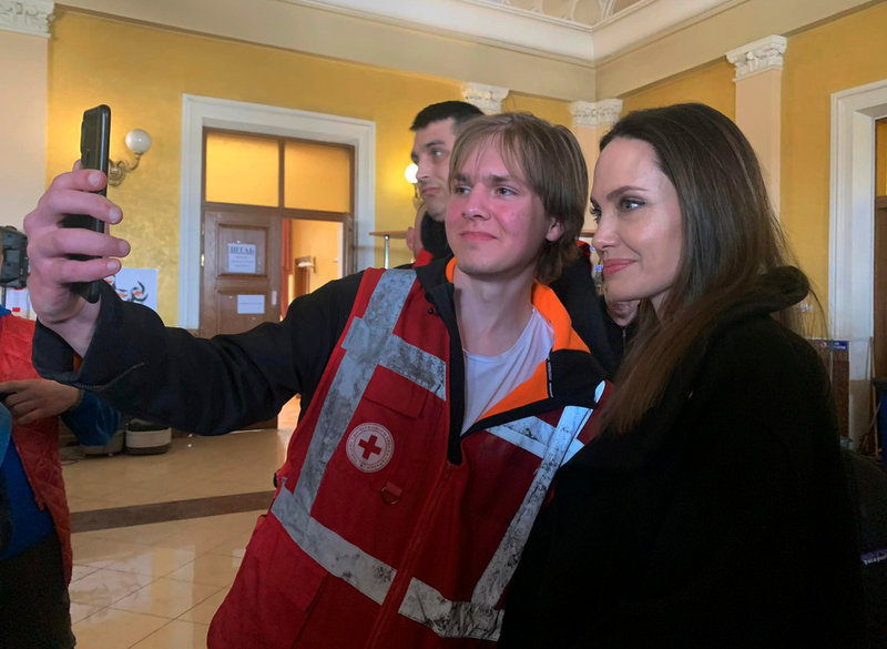 Hollywoodstjärnan och goodwill-ambassadören Angelina Jolie poserar med en hjälparbetare i Lviv.