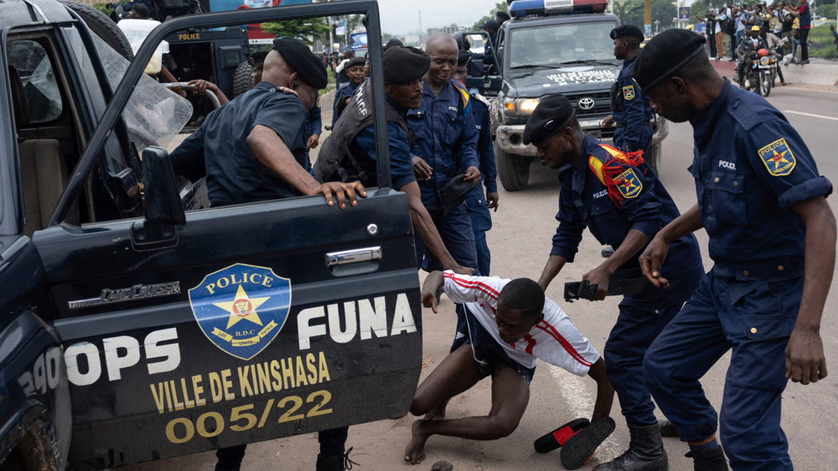 En demonstrants grips av polisen under onsdagens protester i Kinshasa.