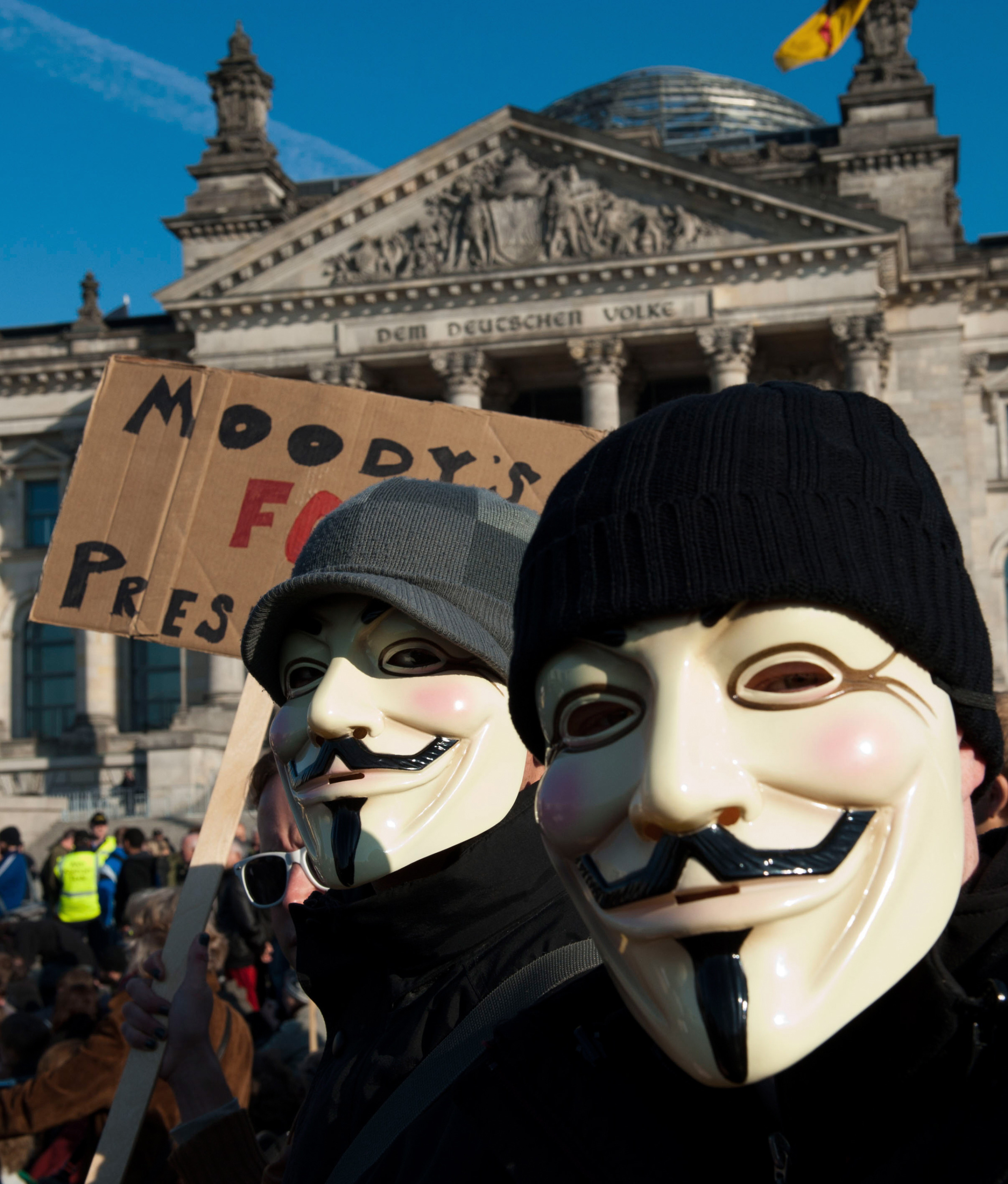 Två personer i Guy Fawkes-masker vid en Occupy-demonstration i Berlin.