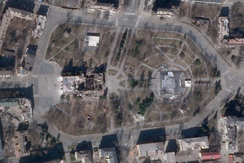Den sönderbombade teatern i Mariupol ses i mitten till vänster på en satellitbild från den 21 mars.