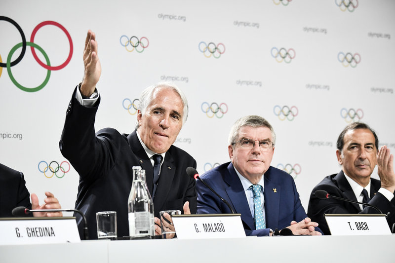 Italienska olympiska kommitténs ordförande Giovanni Malagó, till vänster, och Internationella olympiska kommitténs dito Thomas Bach, mitten, efter att Italien tilldelats vinter-OS 2026. Arkivbild.