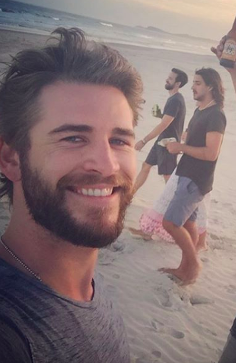Liam Hemsworth på stranden med två vänner. Liam Hemsworth på stranden med två vänner.