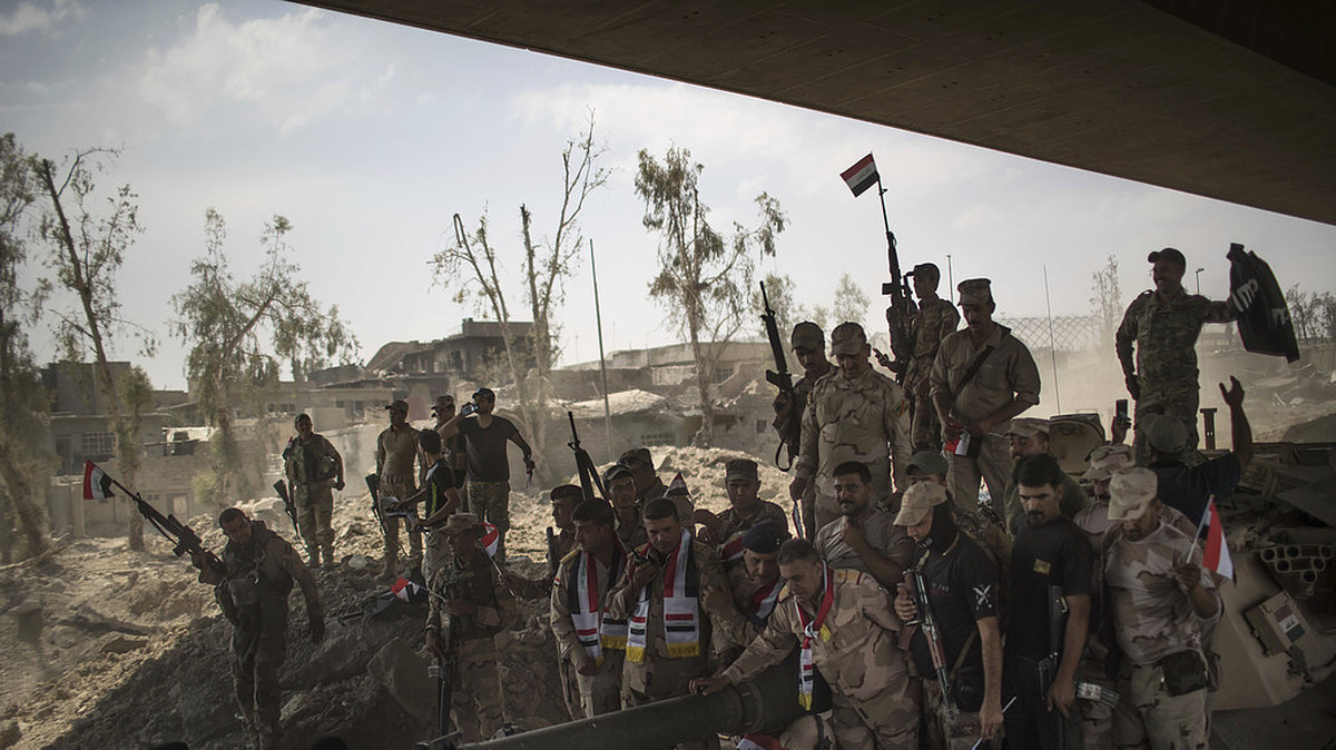 Bilden visar de irakiska soldaternas firande efter att regeringen deklarerat IS besegrade.