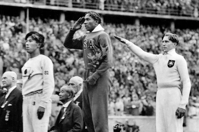 Jesse Owens, mitten, under OS i Berlin 1936. Till höger står den tyska silvermedaljören Luz Long och till vänster japanen Naoto Tajima.