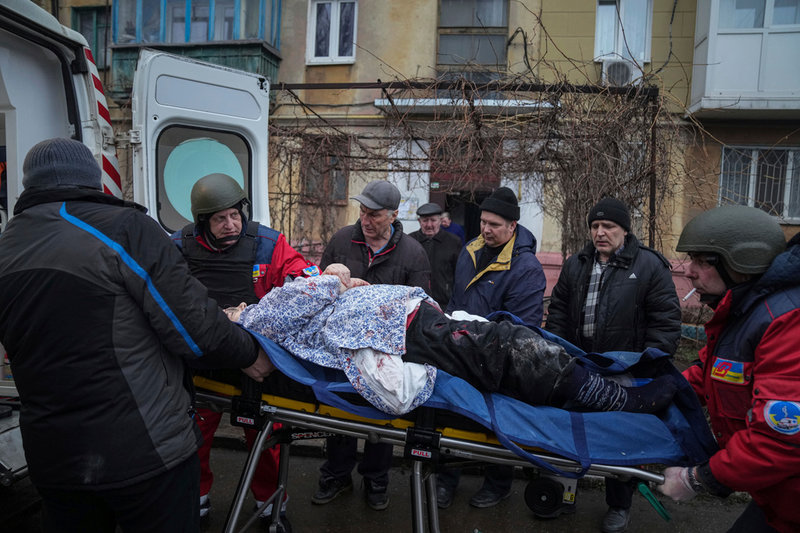 Ambulans hämtar en civil man som skadats under artilleriangrepp i Mariupol den 2 mars.