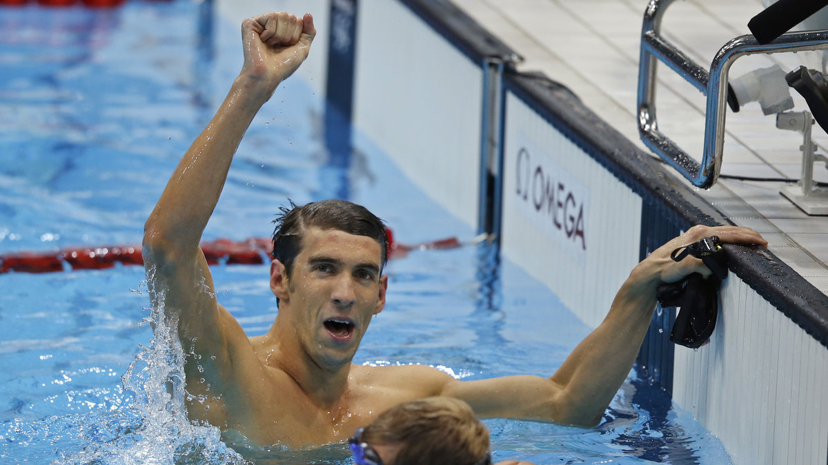 Phelps, som tog fyra guld och två silver i OS, kan bli av med sina medaljer efter att ha brutit mot IOK:s reklamregler.