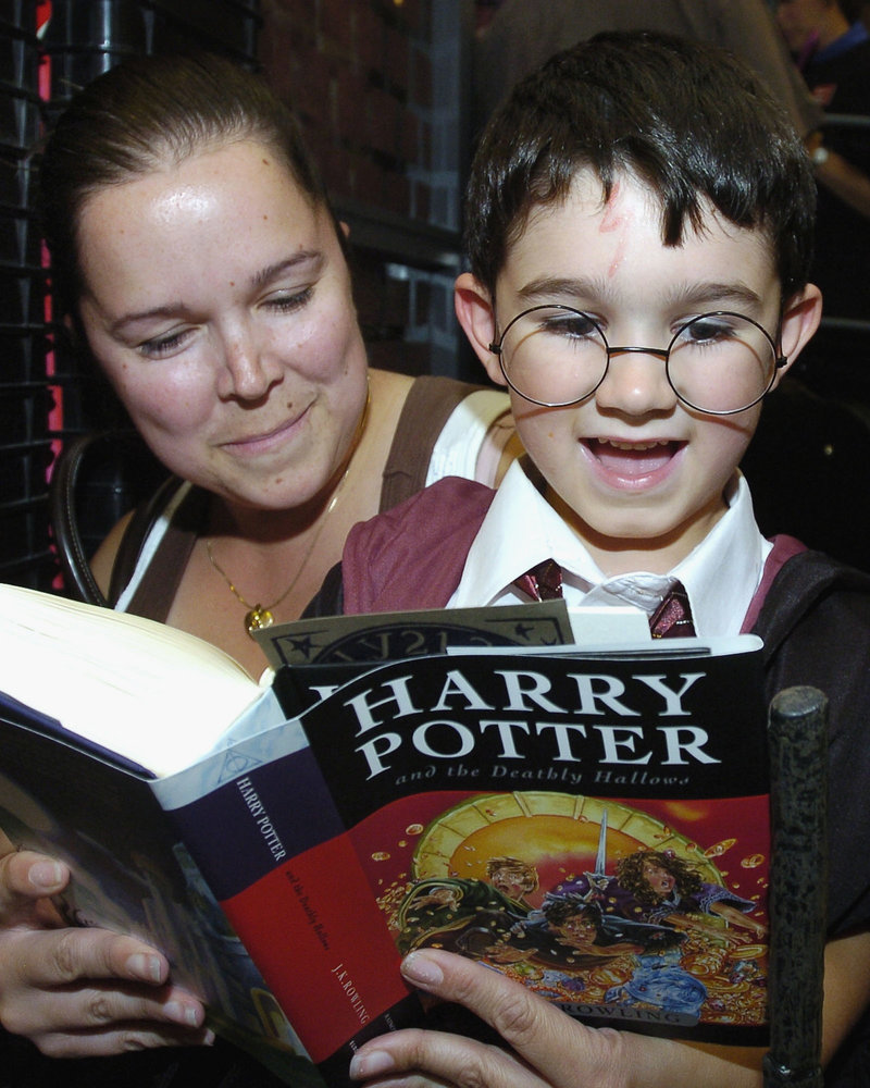 An adult and a kid reading Harry Potter. An adult and a kid reading Harry Potter.