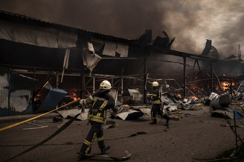 Brandmän försöker släcka en brand efter en attack i Charkiv på lördagen.