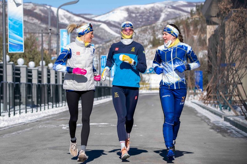 Frida Karlsson och Maja Dahlqvist under en löprunda i OS-byn i Zhangjiakou i vintras, tillsammans med Moa Olsson, längst till höger.