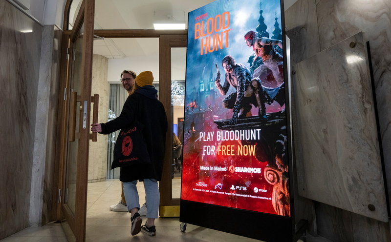 En digital affisch för spelet 'Bloodhunt' i entrén hos spelutvecklaren Sharkmob vid Stortorget i Malmö.
